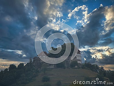 Lenzburg Castle on the castle mountain under a dramatic sky. Stock Photo