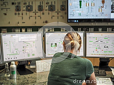 LEOBEN, AUSTRIA - 05/22/2019: Woman in front of control panels in Goss Brewery Editorial Stock Photo