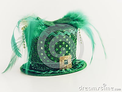 Leprechaun hat, green and gold with polka dots, feathers and beads, sparkly and shiny for St. Patrickâ€™s Day Stock Photo