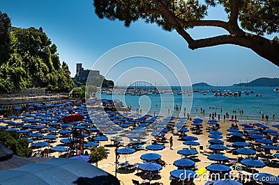 Lerici, Liguria, Italy. June 2020. The silhouette of a pine trunk with the background of the castle of Lerici frame the beach full Editorial Stock Photo