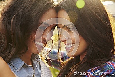 Lesbian couple embrace outdoors look to each other, close up Stock Photo