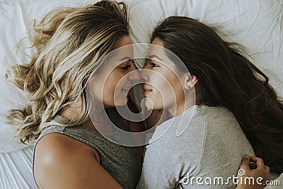 Lesbian couple together in bed Stock Photo