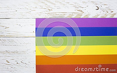 Lesbian, Gay, Bisexual and Transgendered Flag The rainbow pride flag of the LGBT organization, on a white wooden board with space Stock Photo