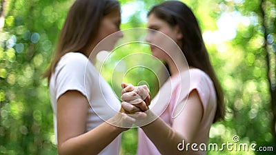Lesbians holding hands, feel attraction to each other, trustful same-sex love Stock Photo