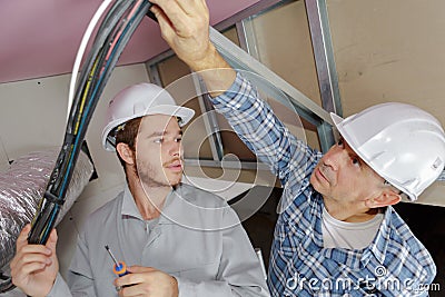 Lesson with electrician and apprentice Stock Photo