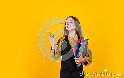 After lesson. happy kid model holding school folder. making notes. teen girl ready to work. writing and reading info Stock Photo