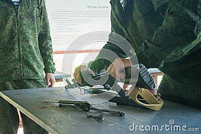 Military camp. Assembling an automatic gun Stock Photo