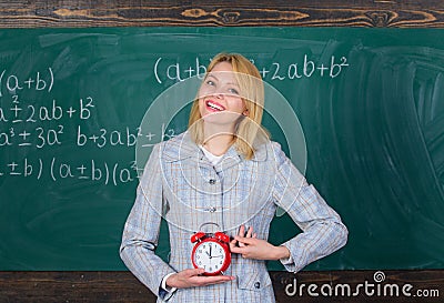 Lessons schedule. Welcome teacher school year. Experienced educator start lesson. What time is it. She cares about Stock Photo