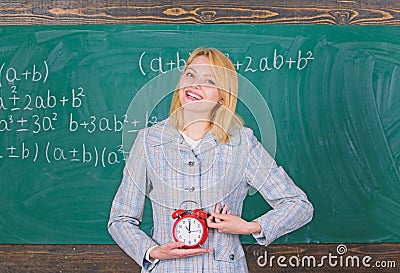 Lessons schedule. Welcome teacher school year. Experienced educator start lesson. What time is it. She cares about Stock Photo