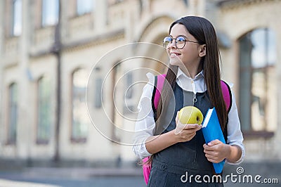 Let food be your medicine. Happy kid hold apple and book. School snack. Brain food. Healthy eating habits. Nutrition Stock Photo