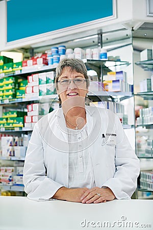 Let me attend to all of your wellness needs. Portrait of a happy mature woman working in a pharmacy. Stock Photo