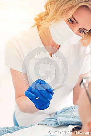 Female dental professional examining patient teeth Stock Photo