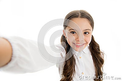 Let me take a selfie. Child girl school uniform clothes holds smartphone takes photo. Child school uniform kid happy Stock Photo