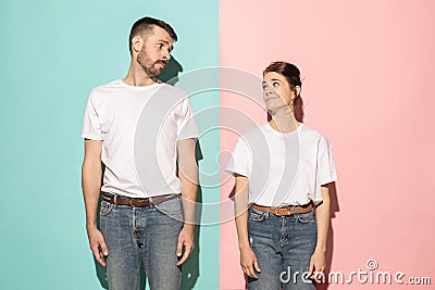 Let me think. Doubtful pensive couple with thoughtful expression making choice against pink background Stock Photo