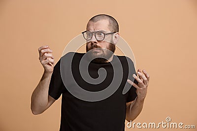 Let me think. Doubtful pensive man with thoughtful expression making choice against pastel background Stock Photo