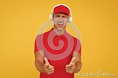 Let music speak. Happy man give thumbs ups yellow background. Enjoying favorite music. Handsome guy wear headphones Stock Photo