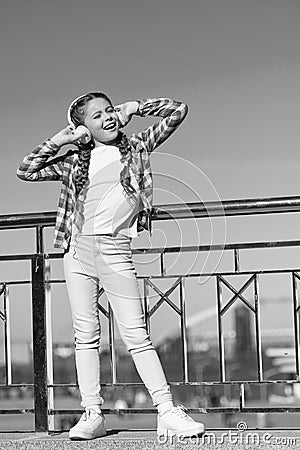 Let the music speak. Small girl listen to music outdoor. Happy small girl. Happy child wear headphones. Small music fan Stock Photo