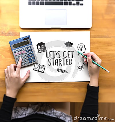 LET'S GET STARTED Two Businessman working at office desk and usi Stock Photo