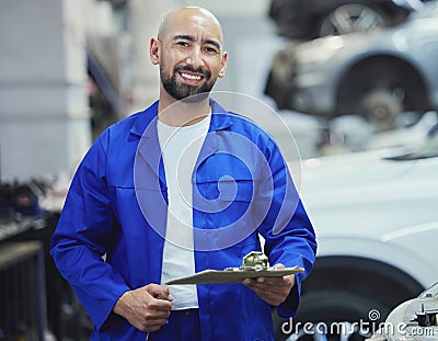 Lets assess your vehicle. Cropped portrait of a handsome young male mechanic working on the engine of a car during a Stock Photo