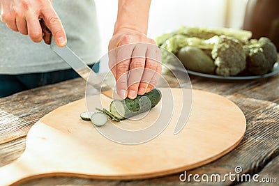 Natural cucumber being cutting. Stock Photo