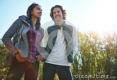 Lets find some beautiful place to pitch a tent. an adventurous young couple at their campsite. Stock Photo