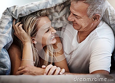 Lets just cuddle all day. an affectionate couple spending the day in bed. Stock Photo