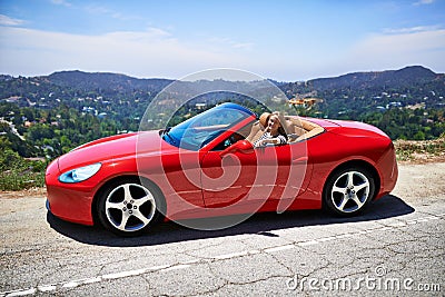 Lets open this baby up. a young woman driving in a sports car. Stock Photo