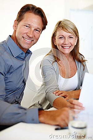 Lets show the youngsters how its done. Mature business professionals looking at the camera. Stock Photo