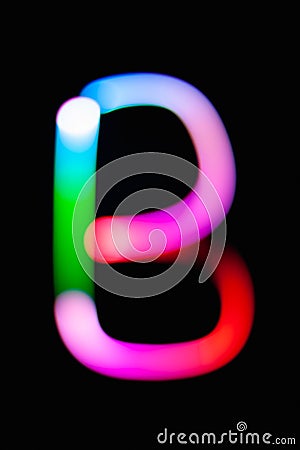 Letter B. Glowing letters on dark background. Abstract light painting at night. Creative artistic colorful bokeh. New Year. Stock Photo