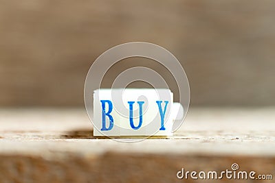 Letter block with blue color word buy on wood background Stock Photo