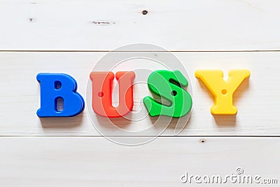 Letter block in word busy on wood background Stock Photo