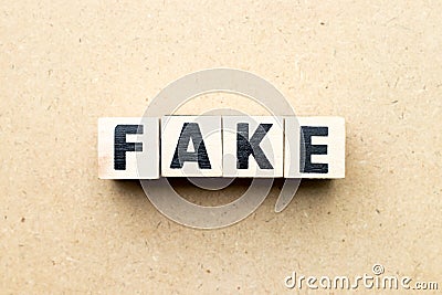 Letter block in word fake on wood background Stock Photo