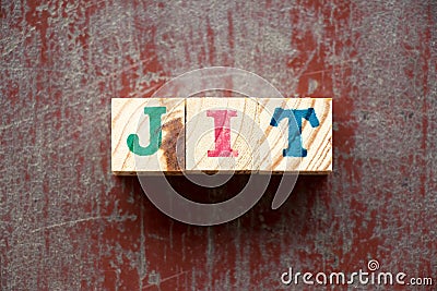 Letter block in word JIT Abbreviation of just in time on red wood background Stock Photo