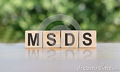 Letter block in word MSDS Abbreviation of material safety data sheet on gray-green background Stock Photo