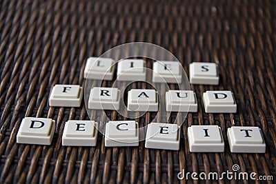 Letter blocks spelling out the words fraud deceit and lies Stock Photo