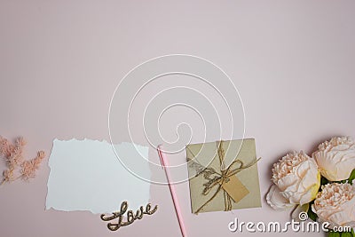 Letter concept with a white letter, flowers, envelope on a pink background Stock Photo