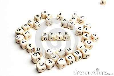letter cubes lying on white table. Byte Stock Photo