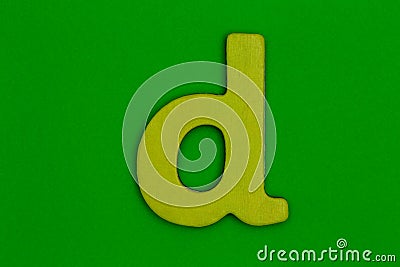 Letter d made of wood painted yellow on green background Stock Photo