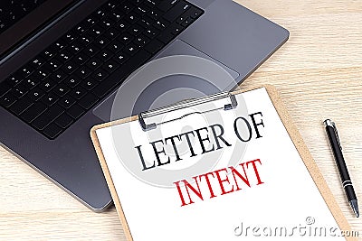 LETTER OF INTENT text on clipboard on laptop Stock Photo