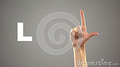 Letter L in sign language, hand on background, communication for deaf, lesson Stock Photo