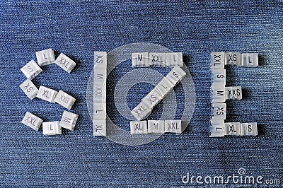 Letter SIZE from various plastic clothing size tags Stock Photo