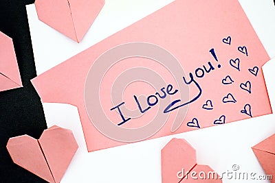 Letter with text I Love You! with envelope and pink origami hear Stock Photo