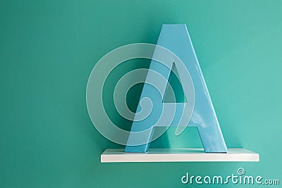 Letter A turquoise color on a white shelf Stock Photo