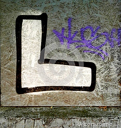 Letter on a wall. Street graffiti. Stock Photo