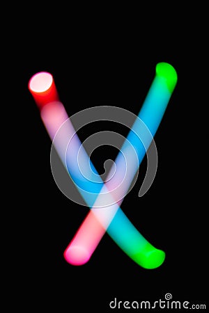 Letter X. Glowing letters on dark background. Abstract light painting at night. Creative artistic colorful bokeh. New Year. Stock Photo