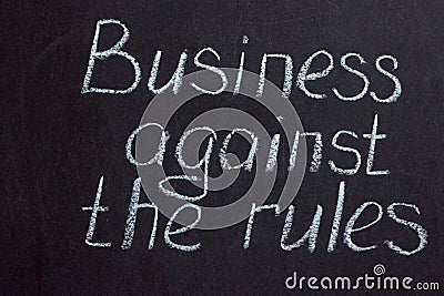 Lettering on chalkboard Business against rules Stock Photo