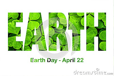 Lettering Earth Day April 22 on the background of clover. Earth day concept, protection of the planet from pollution, improvement Stock Photo