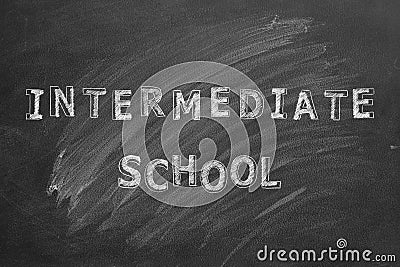 Intermediate school. Text on blackboard Stock Photo