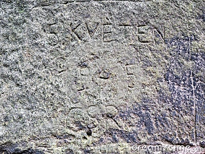 Letters engraved by vandals into sandstone rock Stock Photo