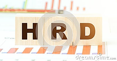 Letters hrd on wooden blocks on table with different graphs Stock Photo